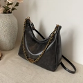 Minimalist black tote bag with vintage texture and golden chain strap in 45-degree view - Black