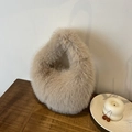 Plüschige Kunstfell Handtasche in Beige, luxuriöse weiche Wintertasche auf Holzdekor - Khaki