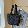 Black quilted tote bag with floral embroidery and matching mini zipper pouch accessory - Black