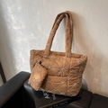 Brown quilted tote bag with floral embroidery and matching pouch on a leather seat - Brown