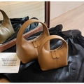 Detail of minimalist brown crescent handbags with vertical stitching and dual zippers - Large / Brown