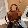 Vintage brown glossy bowling handbag for women with a cute plush bear pendant accessory - Brown