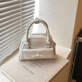 Chic cream white Boston bag with elegant bow detail and dual handles for women - White