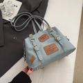 Light blue faux leather handbag with vintage brown patches and gold hardware accents - Blue Without Charm