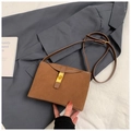 Brown frosted suede crossbody bucket bag with golden buckle on elegant blazer backdrop - Brown No Pendant