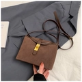 Retro dark brown frosted crossbody bucket bag with golden twist lock on grey blazer - Brown No Pendant