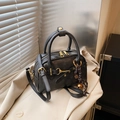 Vintage black boston handbag with gold hardware and logo charm on beige blazer - Black with Pendant