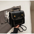 Detail of black faux leather backpack with gold studs and brand lettering on bedding - No Pendant / Black