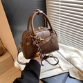 Retro deep brown Boston handbag with double handles and decorative gold bell charm - Brown with Pendant