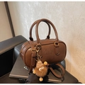 Detail of dark brown pebbled leather Boston bag with embossed ATN and monster charm - With Charm / Coffee