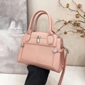Pink lychee texture leather handbag with silver padlock hardware and crossbody strap - Pink