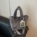 Gray plush bucket bag with soft faux fur texture and a colorful calculator keychain - Grey With Pendant