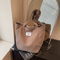 Brown corduroy tote bag for women with Kiss Your Cheek label and dual handles - Khaki