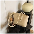 Detail of beige tote bag with litchi texture PU leather and baseball glove pendant charm - Rice White (With Charm)