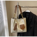 Detail of minimalist tote bag featuring side zipper with tassel and gold chain strap accent - Rice White (No Pendant)