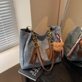 Blue denim tote bag with brown leather handles and gold chain strap in variant colorway - Denim Blue With Pendant