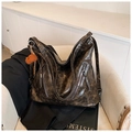 Close-up of vintage oil wax leather tote bag with zippers and cute bear charm pendant - Coffee with Pendant