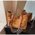 Close-up of caramel suede tote bag featuring embroidered bear and sun patterns - With Bear Pendant / Brown