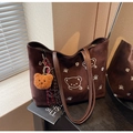 Detail of dark brown suede tote bag with white cartoon bear print and plush charm - With Bear Pendant / Coffee