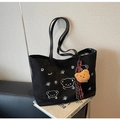 Macro detail of black suede tote bag with cartoon bear embroidery and plush charm - With Bear Pendant / Black