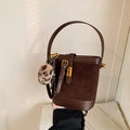 Dark brown suede bucket bag with leather stitching and leopard plush charm - Frosted Coffee with Pendant