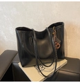 Dettaglio della borsa tote nera minimalista con spalline e ciondolo laterale elegante - Con Ciondolo / Nero