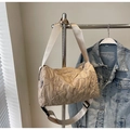 Detail of floral quilted texture on beige canvas cylinder shoulder bag with wide strap - Khaki