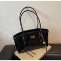 Detail of oil wax leather tote with golden nameplate and stylish bell charm on a book - Black with Pendant