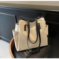 Vista dettagliata della borsa tote in tela con tasche laterali e rivetti dorati - Bianco Sporco