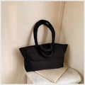 Detail of a black quilted puffer tote bag in lightweight nylon for winter commuting - Black