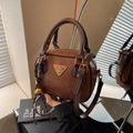 Vintage brown leather square handbag with golden bell charm and adjustable shoulder strap - With Charm / Brown