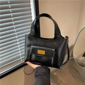 Retro black glossy leather bucket bag with top handles and gold metal logo plaque - Black