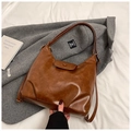 Close-up of vintage brown PU leather Hobo bag with stylish pleated details and flap - Brown