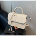 Detail of cream patchwork handbag with tweed fabric and leather on a black book - Off-white