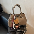 Brown vintage leather handbag with white stitching and bear charm for daily casual wear - Khaki With Pendant