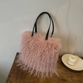 Pink faux ostrich fur tote bag with black leather handles for winter fashion style - Pink