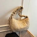 Khaki nylon tote bag with wavy quilting and pleated handle on a vintage chair - Khaki