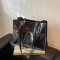 Black leather tote bag with white contrast stitching and transparent front pocket design - Black