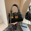 Retro black leather square handbag featuring gold hardware and a mini pendant charm - With Charm / Black