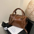 Dunkelbraune glänzende Boston-Tasche aus Leder mit weißen Kontrastnähten und Gold-Hardware - Braun