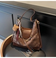 Detail of vintage brown suede tote with teddy bear charm and gold hardware on a chair - Coffee (With Pendant)