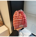 Detail of red and white checkered knit bucket bag with sparkling rhinestone accents - Red