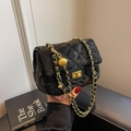 Elegant black quilted crossbody bag with gold chain strap and adjustable metal ball - Black