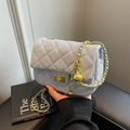 Quilted light blue suede crossbody bag with gold chain strap and decorative golden ball - Blue