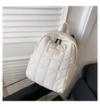 Close-up of cloud-quilted waterproof nylon backpack in beige on a chair background - Off White