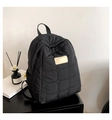 Close-up of black quilted nylon backpack featuring cloud texture and leather logo patch - Black