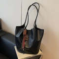 Minimalist black leather bucket tote bag with chocolate pendant and woven tassels - Black with Pendant