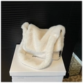 Detailed close-up of soft white faux fur shoulder bag with minimalist side brand tag - White