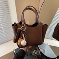 Retro dunkelbraune Beuteltasche aus mattem Leder mit Baseball-Anhänger und Trageriemen - Kaffee mit Anhänger