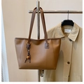 Détail du grand sac cabas marron avec ses longues anses et son pendentif décoratif - Marron avec pendentif